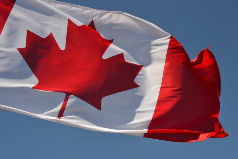 Canada red and white flag under blue sky during daytime